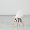 Kids plastic chair with wood-and-metal legs from caramel and sun, Dubai, UAE, pack shot