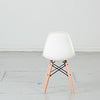 Kids plastic chair with wood-and-metal legs from caramel and sun, Dubai, UAE, back view