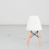 Kids plastic chair with wood-and-metal legs from caramel and sun, Dubai, UAE, front view